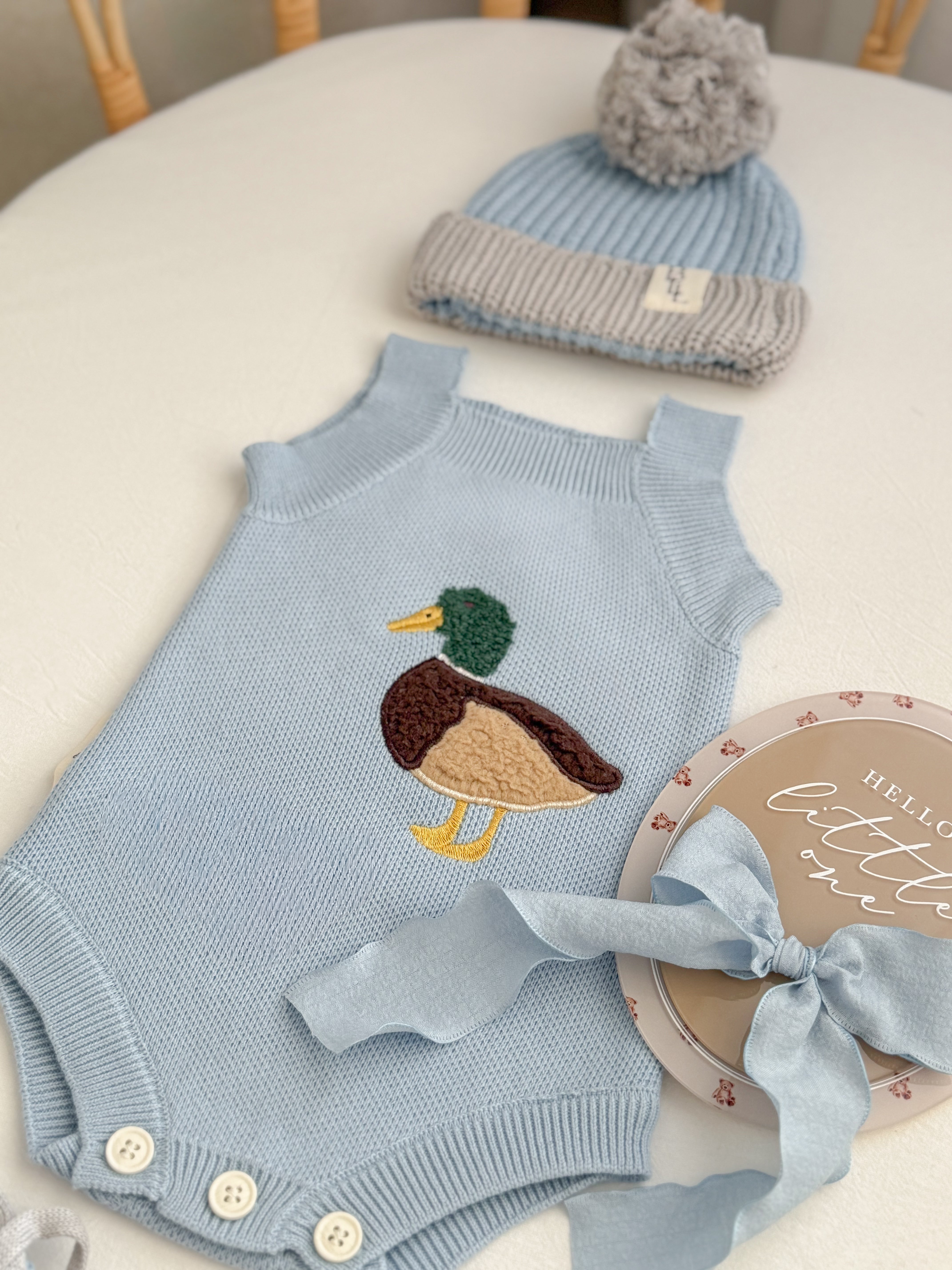 Little Mallard Knit Romper flat lay showing relaxed fit and cotton knit texture — Brave Little Lamb