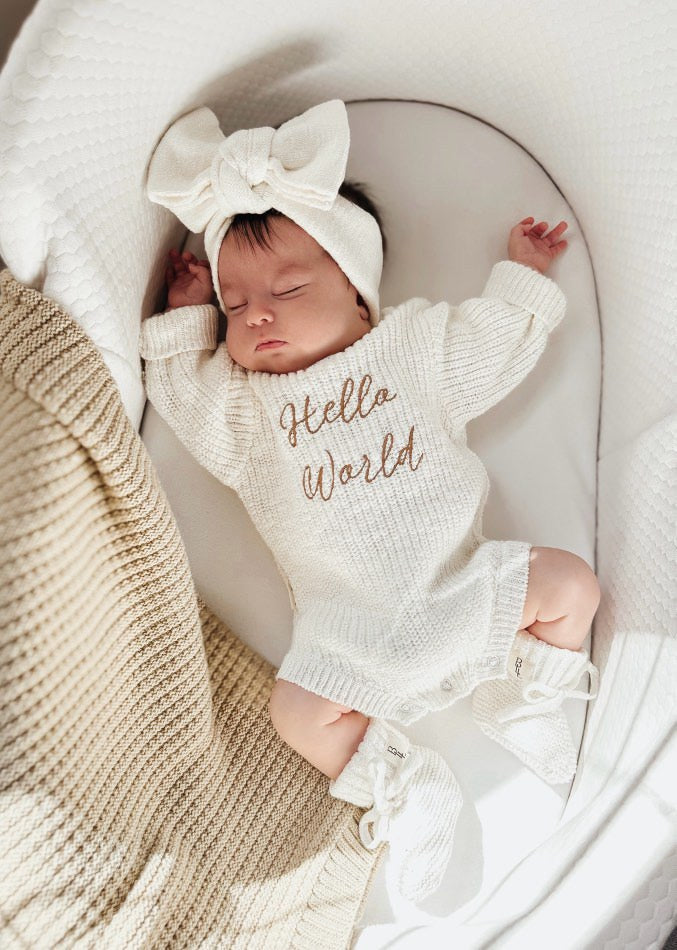 Newborn wearing Hello World romper — white knit baby romper with cursive hello world embroidery — Brave Little Lamb