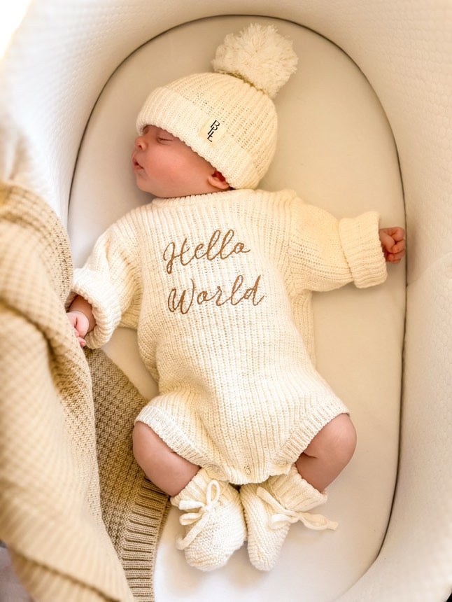Newborn wearing Hello World romper — white knit baby romper with cursive hello world embroidery — Brave Little Lamb