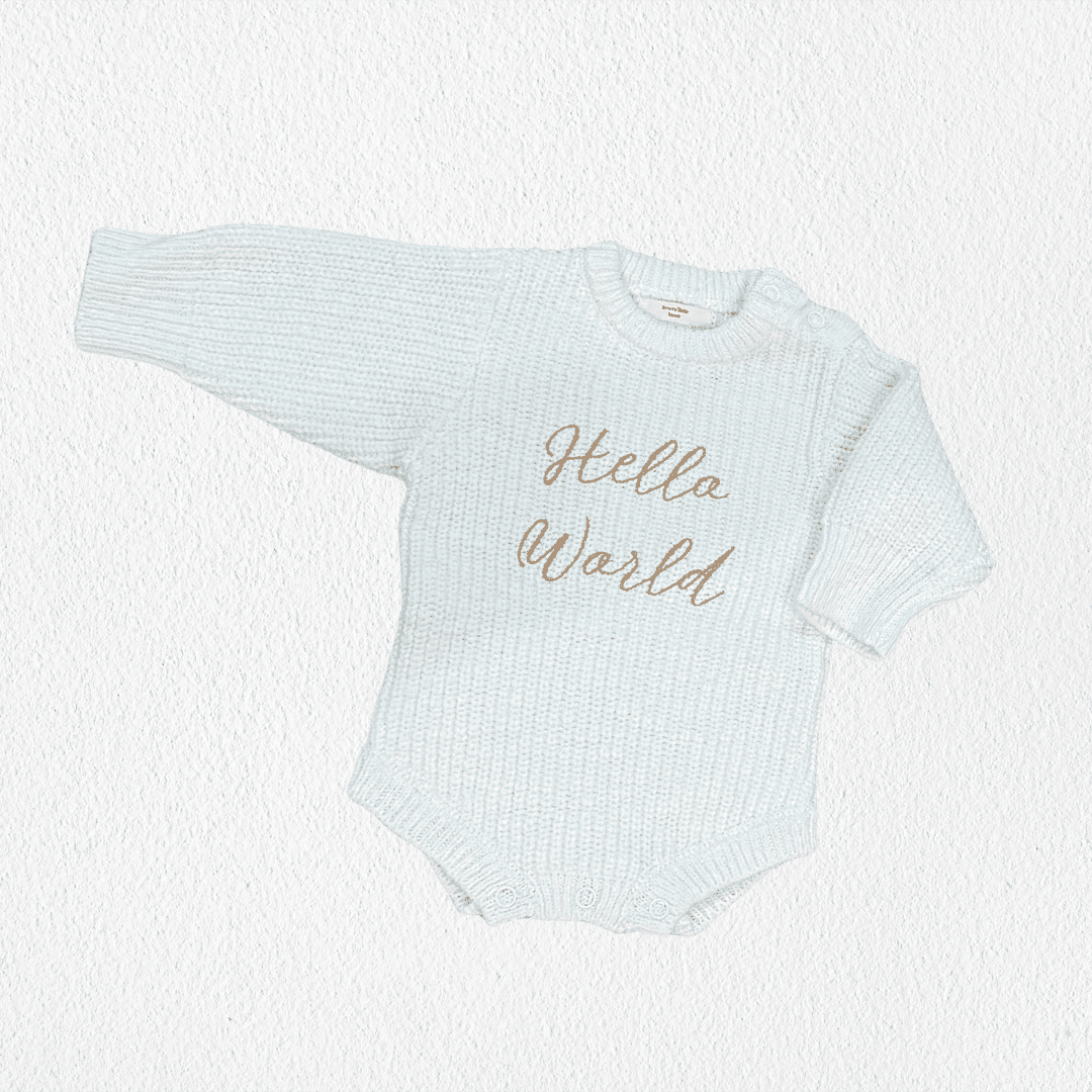 Close-up of hand-embroidered hello world script on textured cloud knit cotton baby romper — Brave Little Lamb