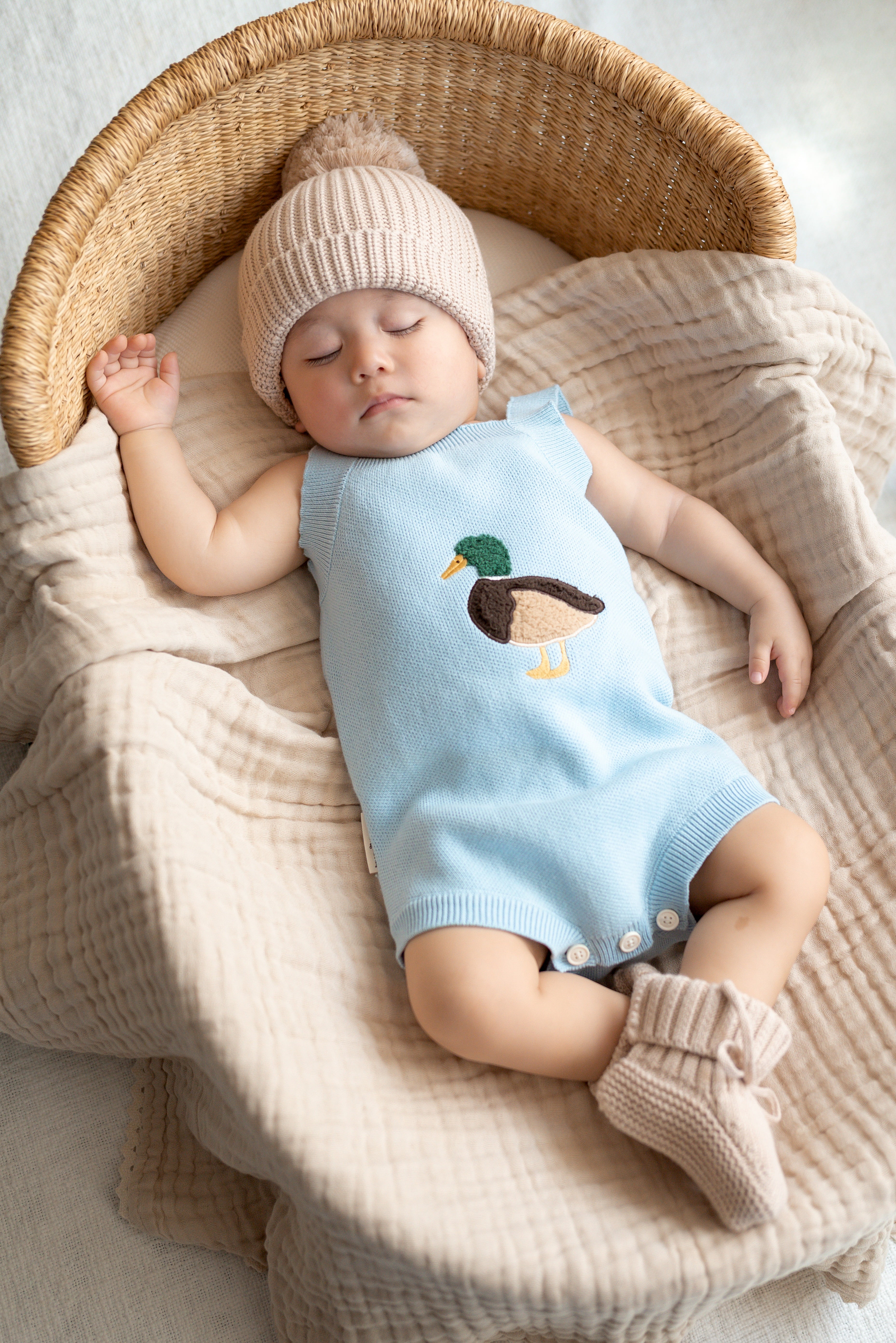 Newborn wearing Little Mallard Knit Romper in soft blue knit — Brave Little Lamb