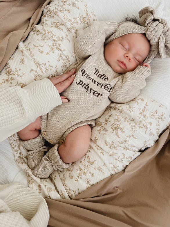 Newborn wearing Little Answered Prayer long-sleeve romper — natural beige cotton knit — Brave Little Lamb