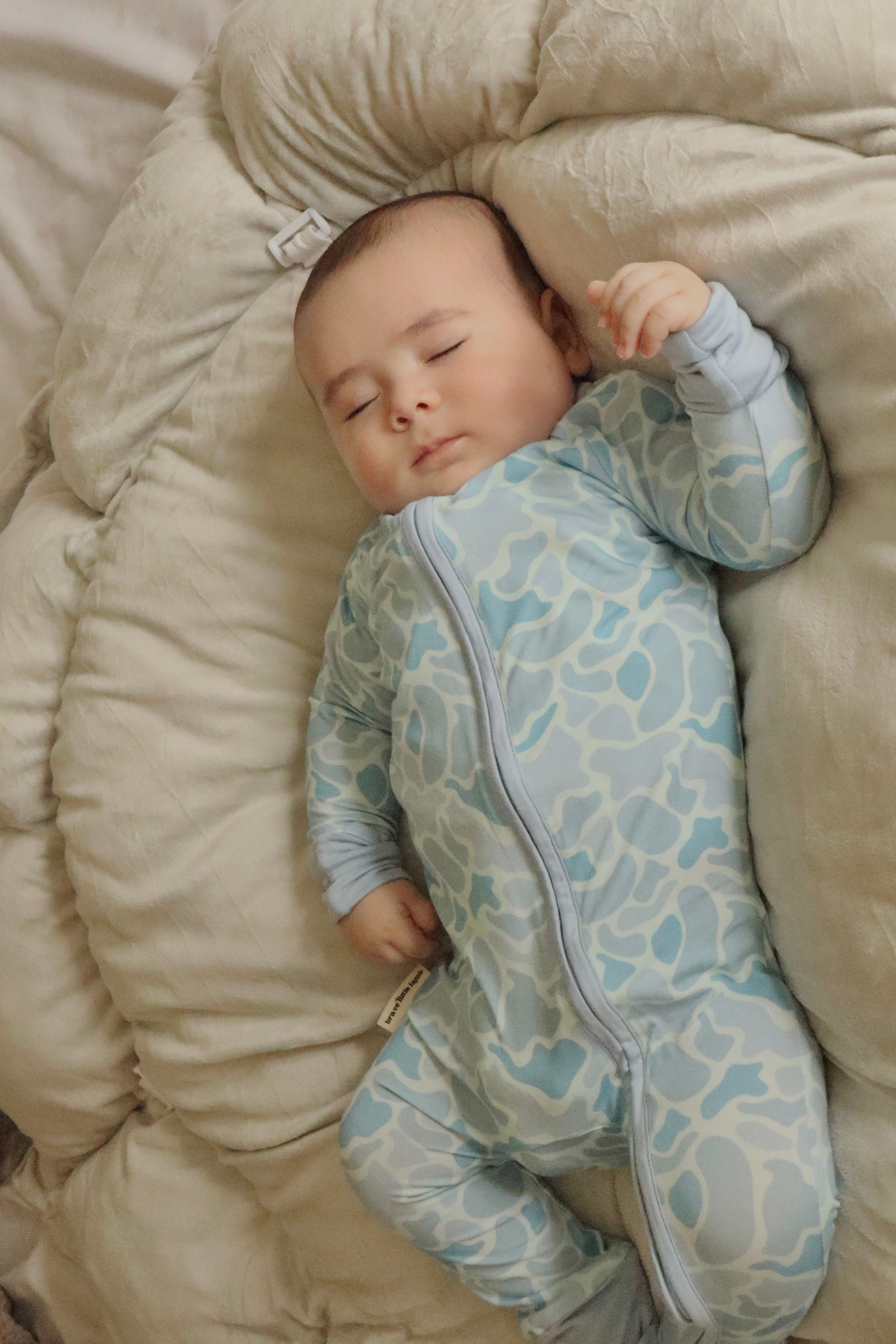 Baby sleeping in Coastal Camo Zip Footie sleeper — Brave Little Lamb