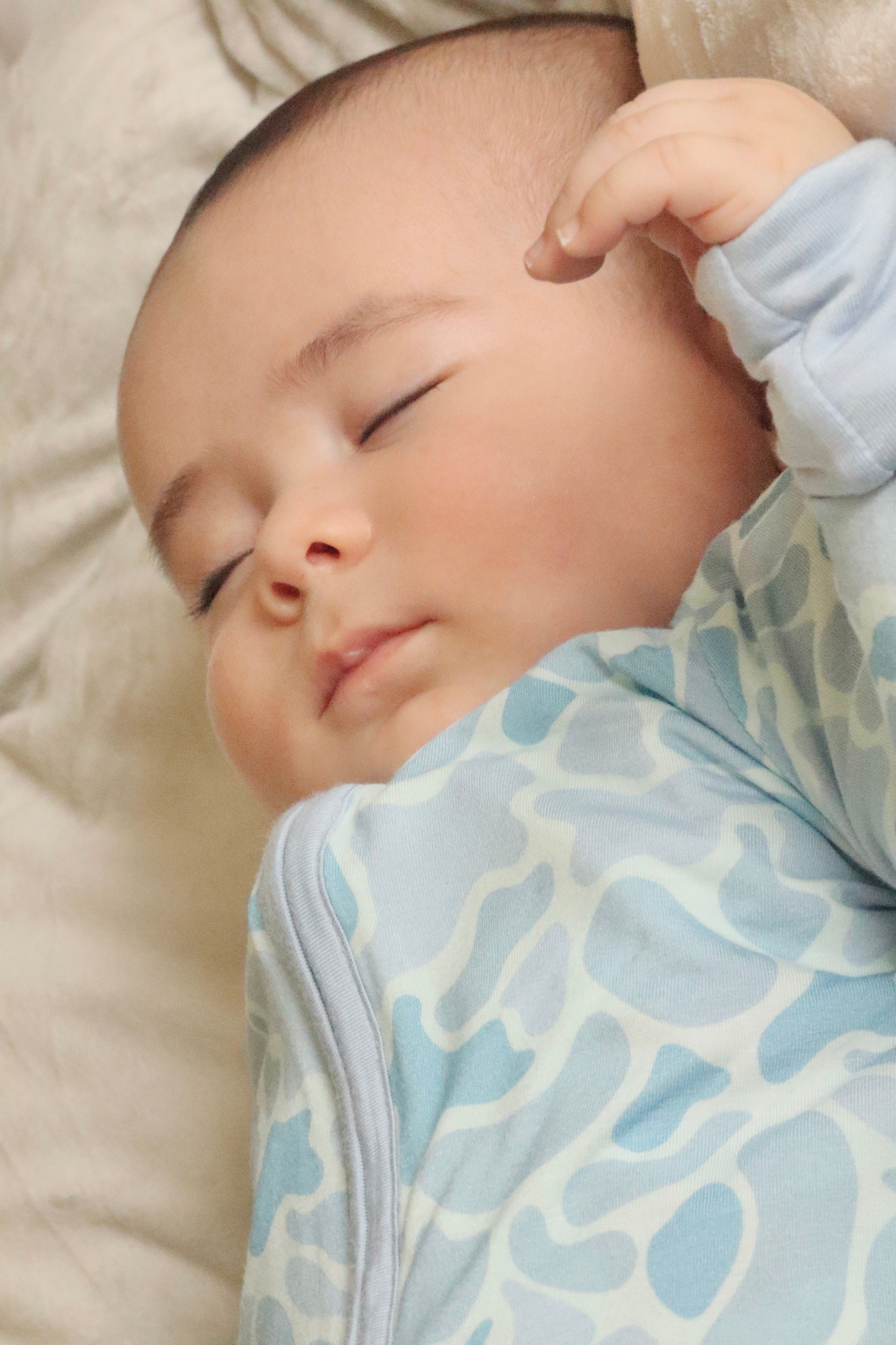 Baby resting in Coastal Camo Zip Footie sleeper — Brave Little Lamb