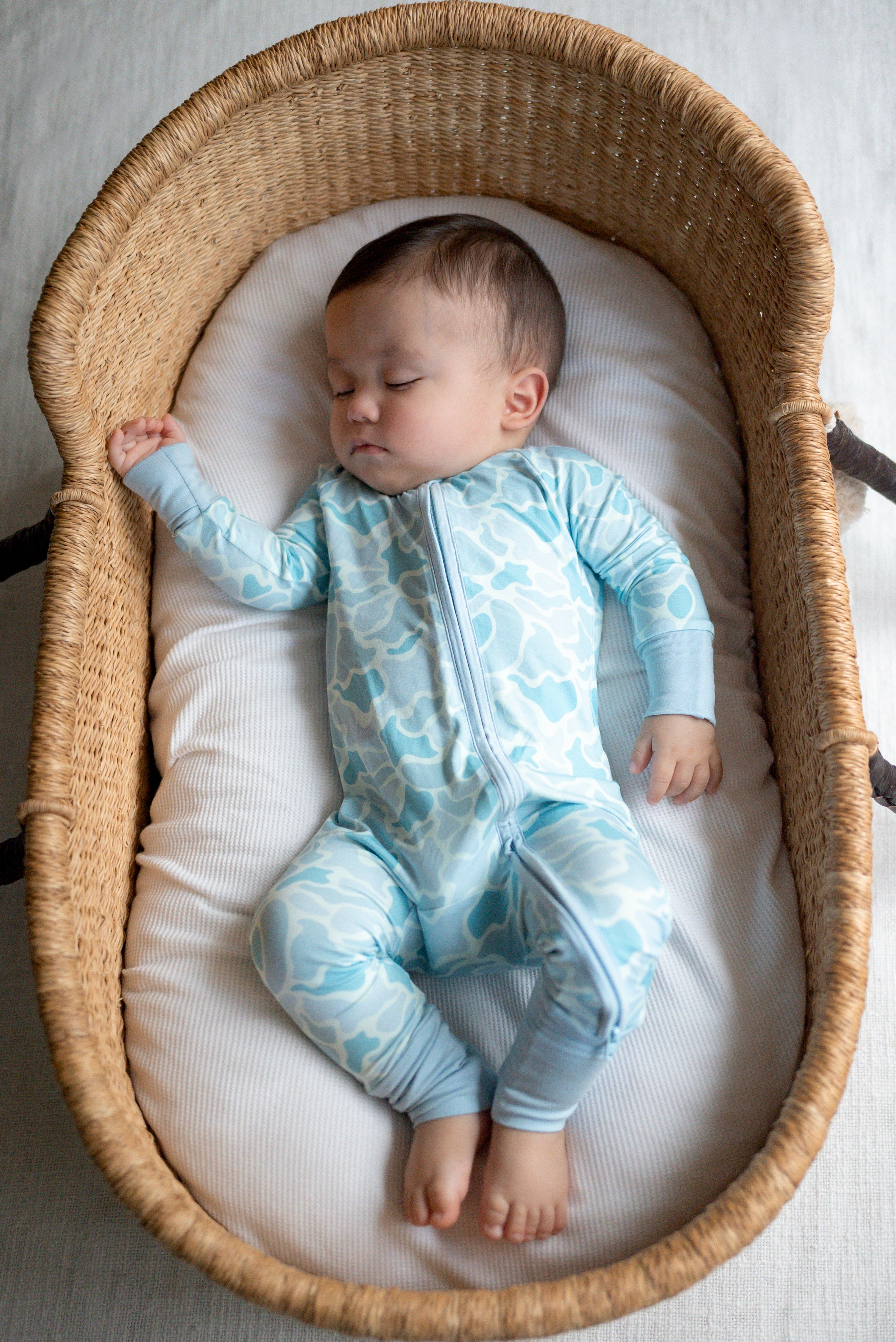 Coastal Camo Zip Footie in blue camo on newborn — Brave Little Lamb