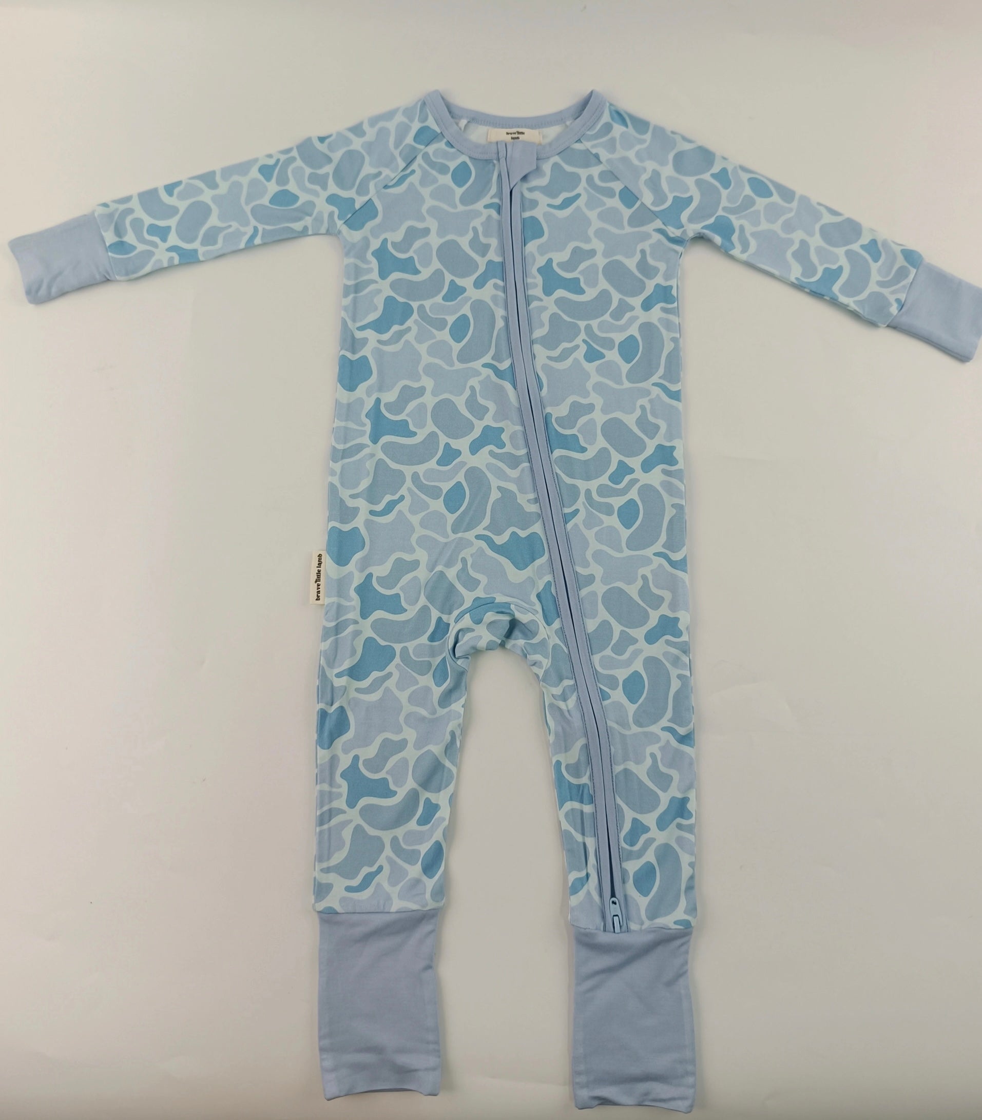 Soft blue camouflage baby footie styled flat lay — Brave Little Lamb