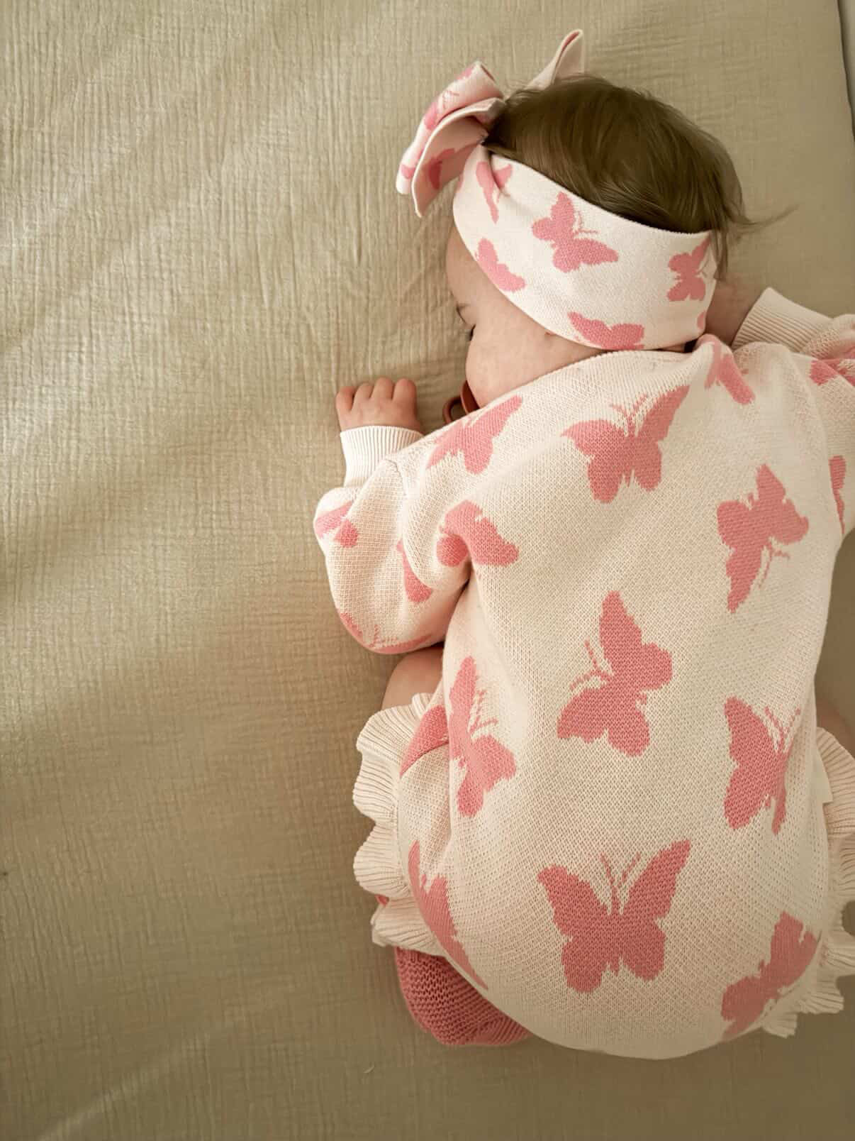Baby wearing Flutter and Frills Knit Romper with bow — Brave Little Lamb