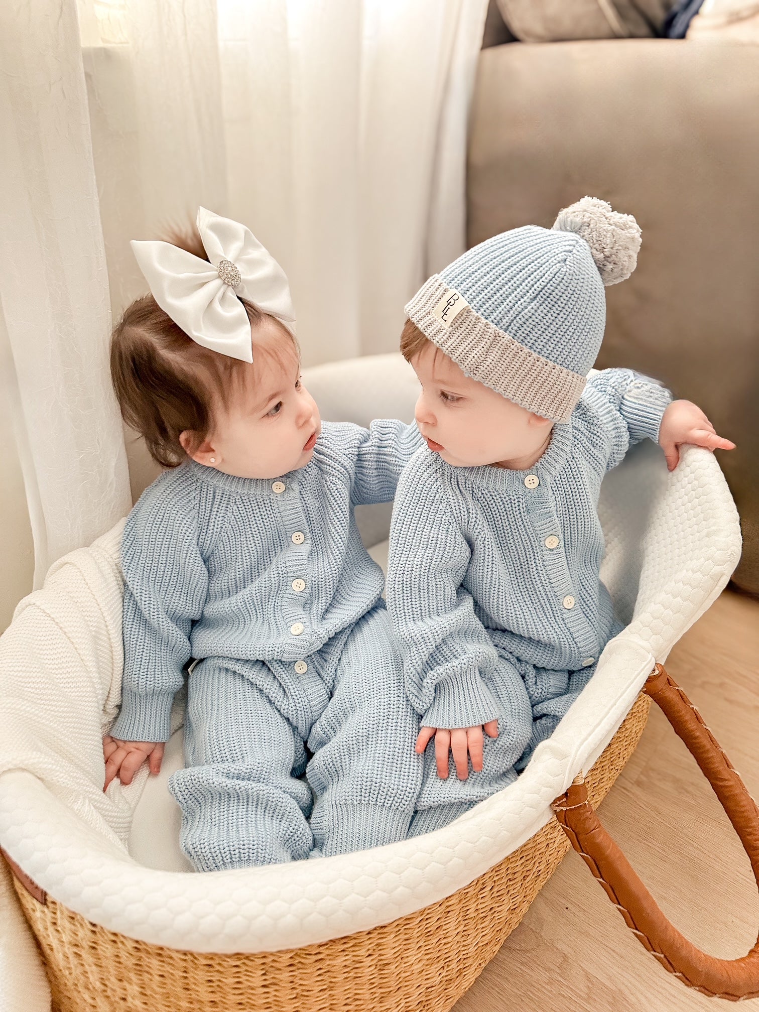 Keepsake Knit Romper in blue on babies in bassinet — Brave Little Lamb