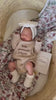 Newborn wearing Little Answered Prayer long-sleeve romper — natural beige cotton knit — Brave Little Lamb